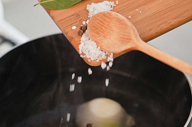 CALIENTA el agua con el vinagre en una olla grande, agrega la cebolla, la sal, la pimienta molida y las hojas de laurel.
