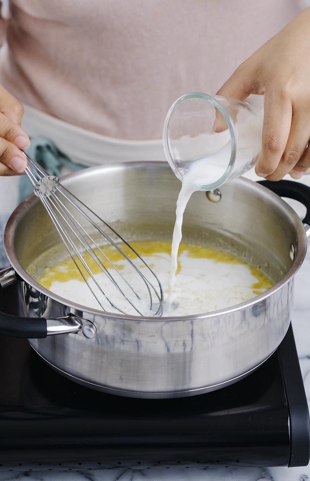 VIERTE la leche y mezcla. Cocina hasta que espese ligeramente.