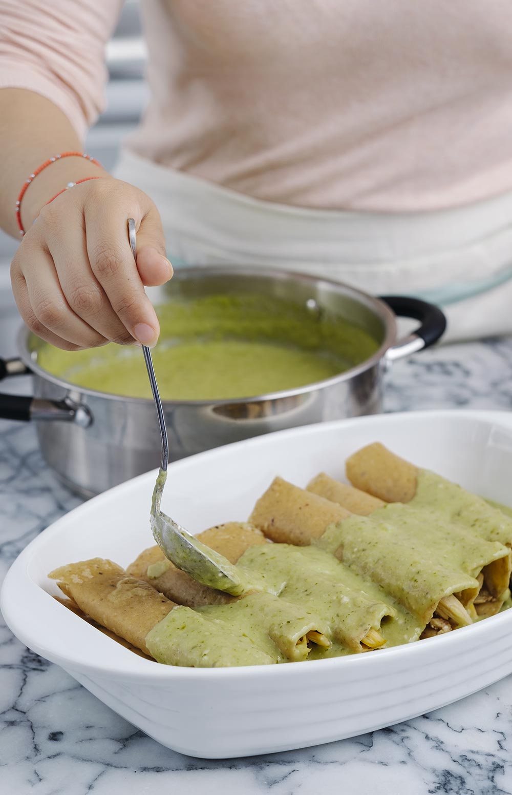 COLOCA en un refractario las enchiladas y vierte la salsa.